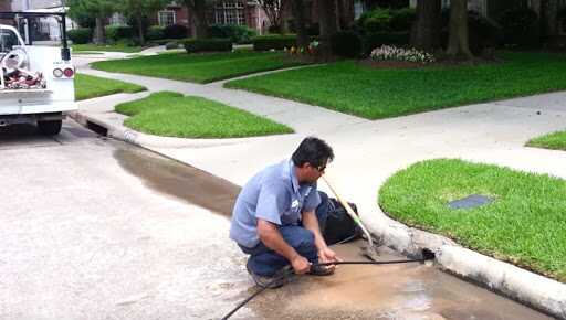Plumber clearing a sewer drain