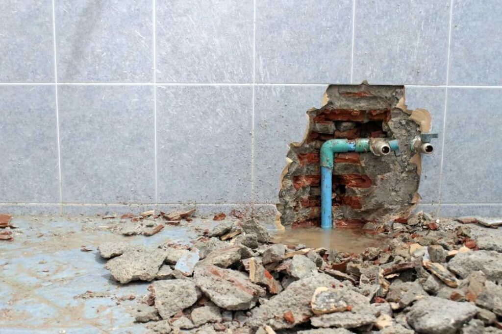 Water damage from leaky pipe caused bathroom tiles to fall off