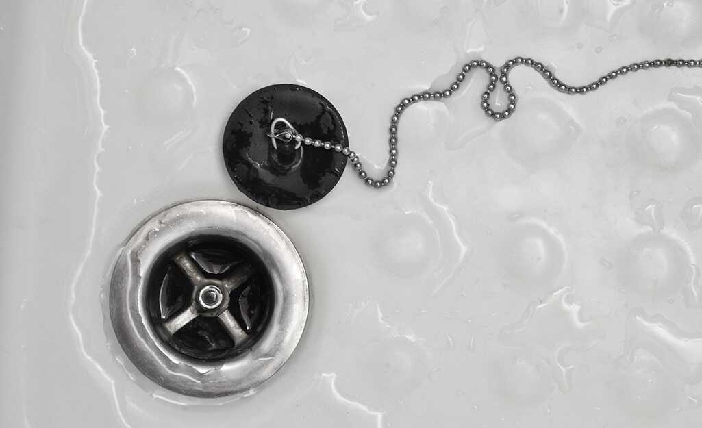 Sink drain with stopper