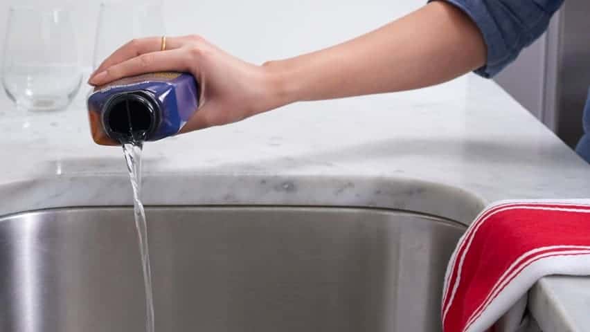 Liquid drain cleaner being poured down a sink