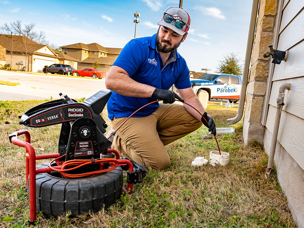 image of technician working on a sewer