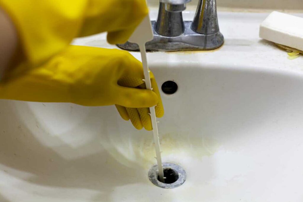 Person snaking a drain