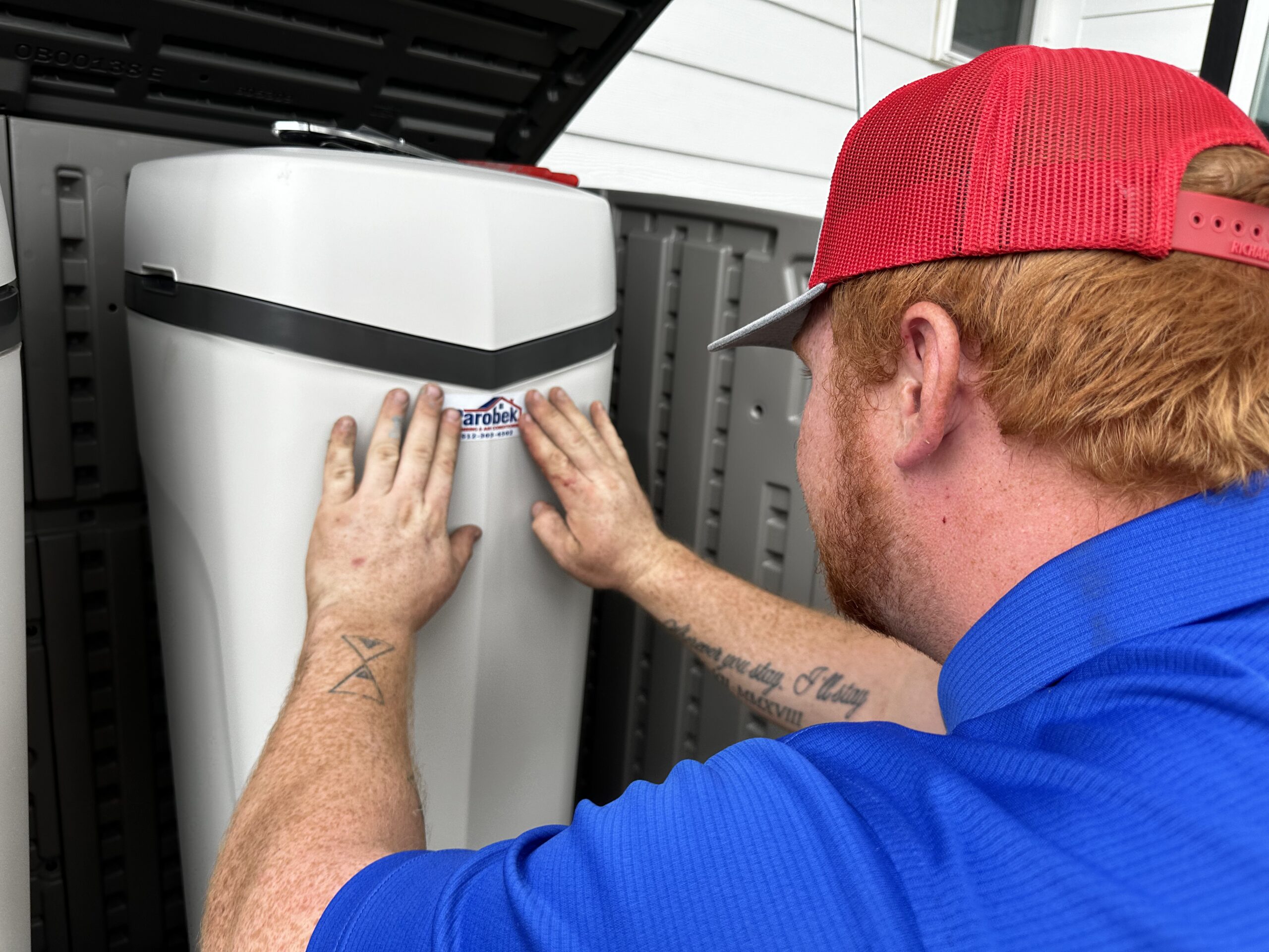 A water softener technician from Parobek working on an install