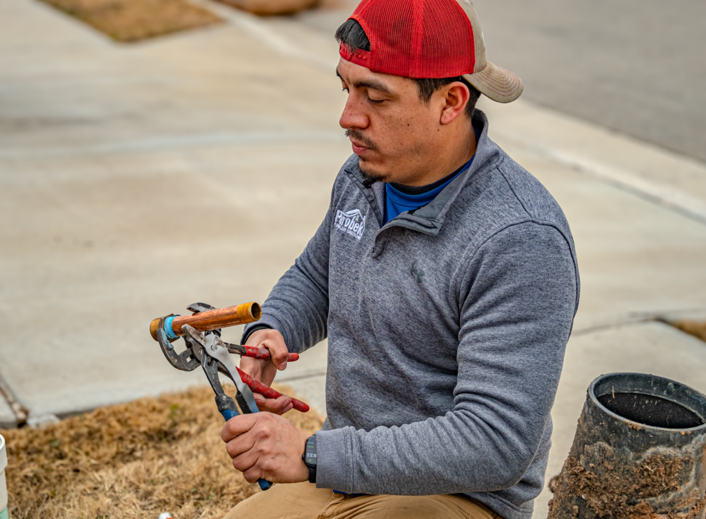 Man working on repiping a house