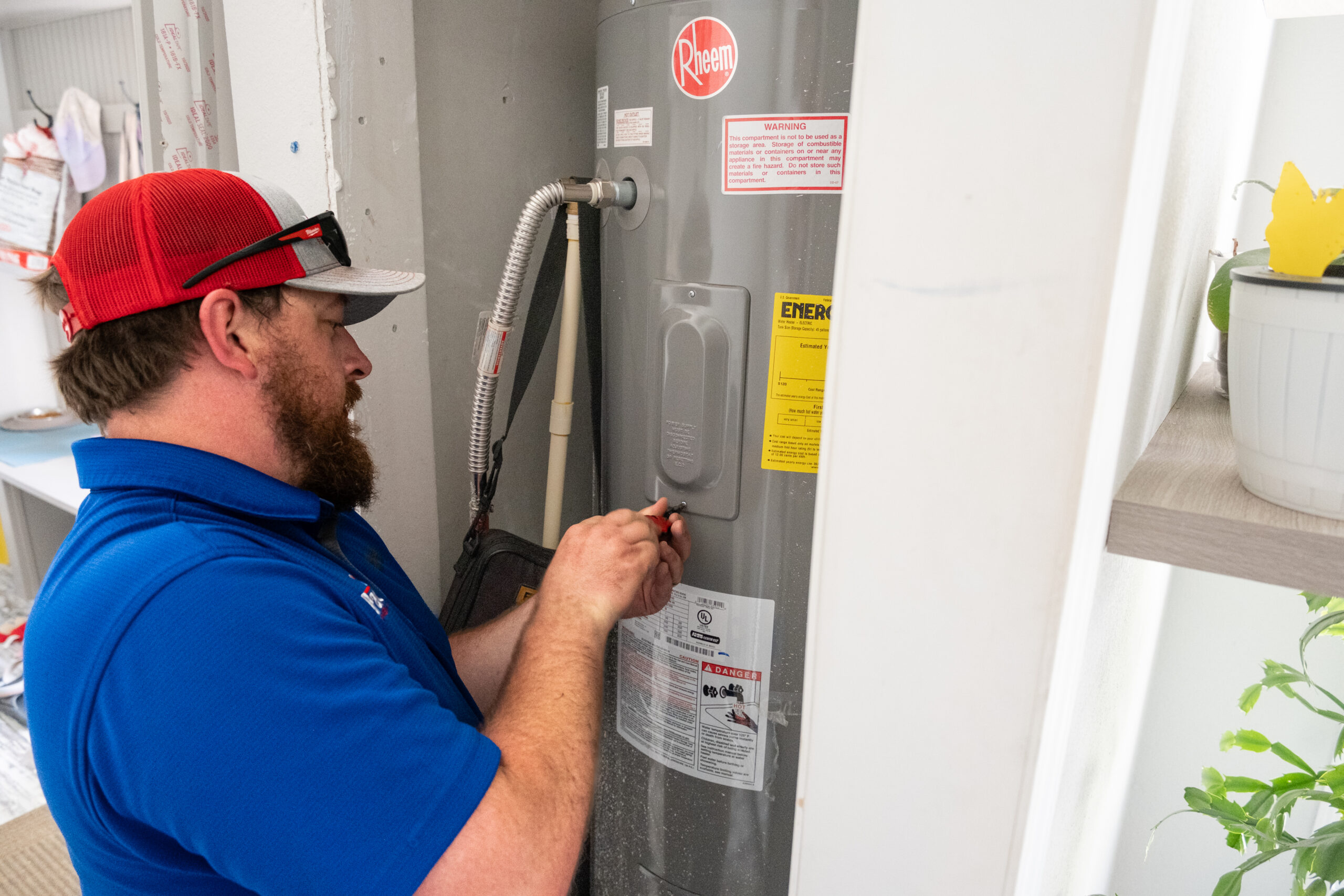 tech working on a water heater