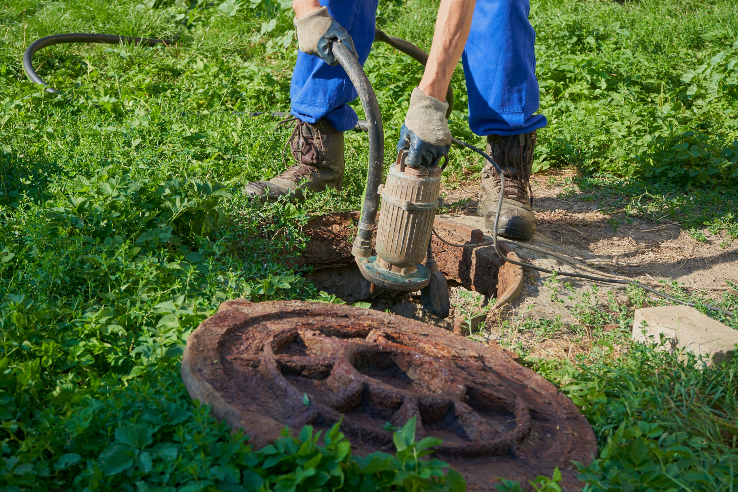 a man holds a hose with a vacuum pump