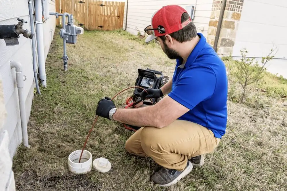 Parobek plumber snaking a drain