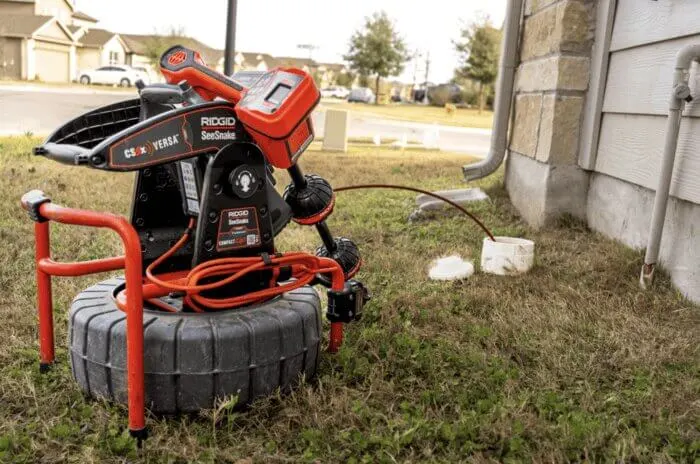 Auger rodding sewer drain