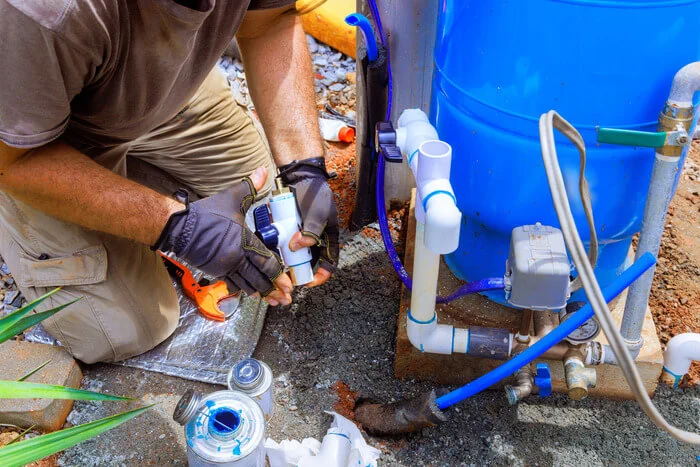 Providing connection service for water well to house water system by a plumber